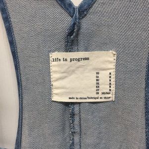 A denim overall dress that has been hardly worn.